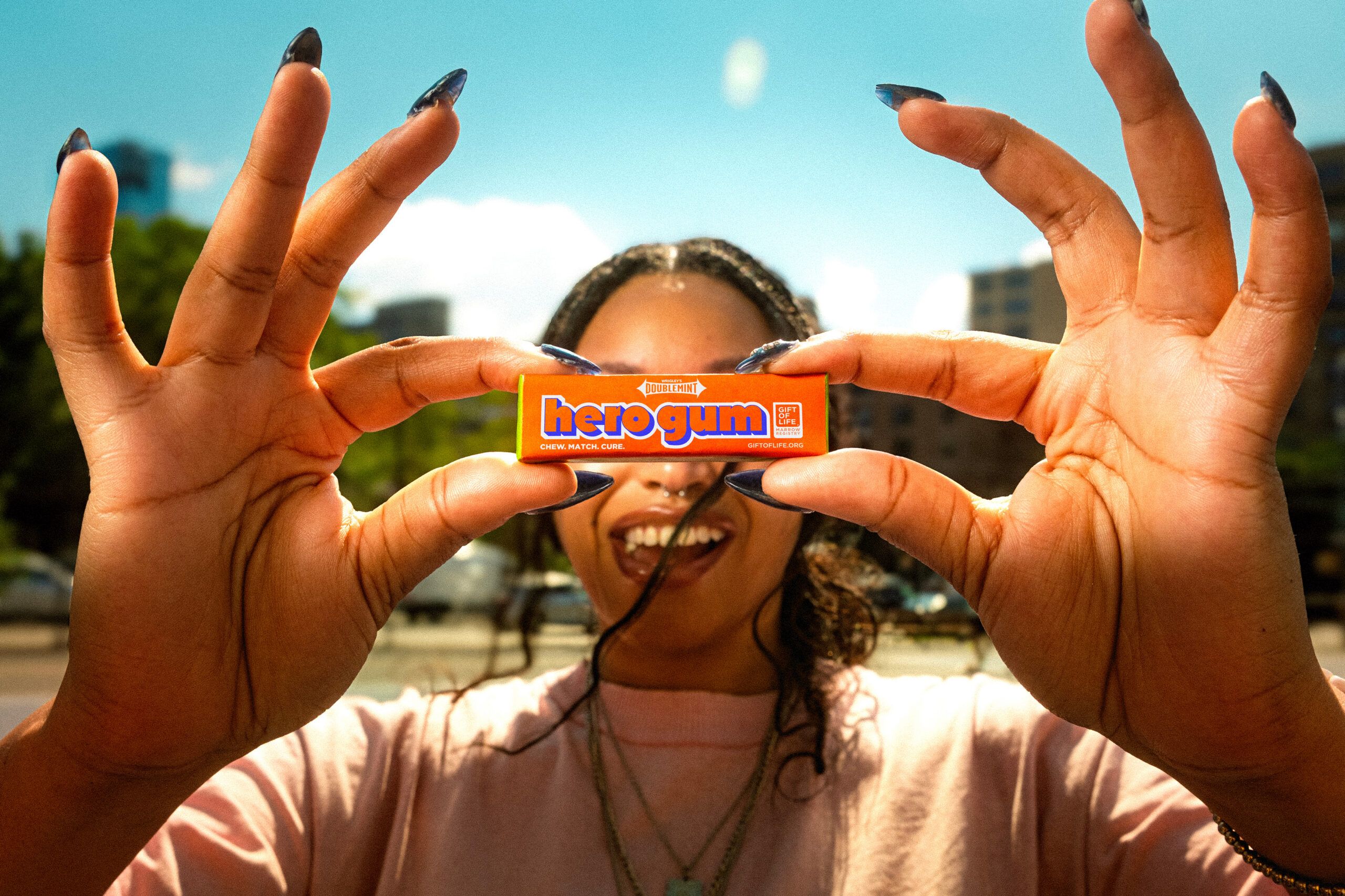 Woman holding a pack of Hero Gum