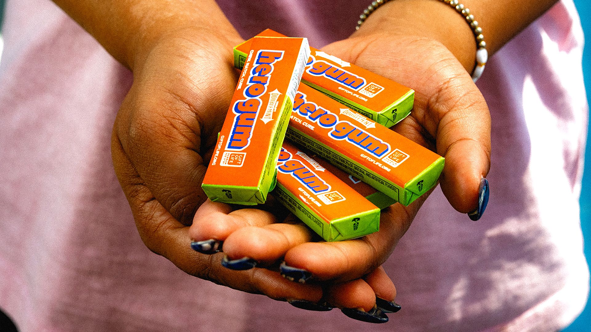 Person holding multiple packs of Hero Gum